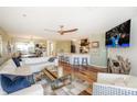 Spacious living room with a view into the kitchen and featuring stylish furnishings and a large screen TV at 18631 Vineyard Point Ln, Cornelius, NC 28031