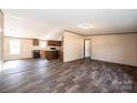 Open concept living area with view of kitchen, laminate floors, and neutral paint at 3553 33Rd Street Ne Dr, Hickory, NC 28601