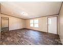 Living room with wood-look laminate flooring, neutral walls, and natural light at 3553 33Rd Street Ne Dr, Hickory, NC 28601