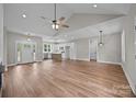 Open living room features hardwood floors with view into kitchen and stainless appliances at 5037 Faith Rd, Salisbury, NC 28146