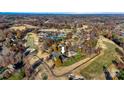 Aerial view of neighborhood, highlighting golf course, tennis courts, and pool at 2425 Birdie Ne Ln, Conover, NC 28613