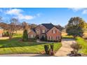 Beautiful two-story brick home with well-manicured lawn and mature trees at 2425 Birdie Ne Ln, Conover, NC 28613