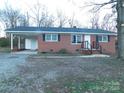 Classic brick ranch home with a covered carport and mature trees at 8600 E Highway 74 E Hwy, Marshville, NC 28103