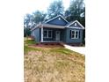 Charming single-story home featuring a covered front porch, and professionally landscaped yard at 1589 Maysville Rd, Shelby, NC 28150