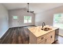 Bright kitchen featuring a marble island, stainless steel appliances, and wood-look floors at 1589 Maysville Rd, Shelby, NC 28150