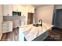 Beautiful kitchen with white cabinetry, granite countertops, a stainless microwave, and modern fixtures at 1589 Maysville Rd, Shelby, NC 28150