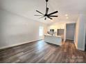 Open-concept kitchen with white cabinets, a marble countertop island, and modern pendant lighting at 1589 Maysville Rd, Shelby, NC 28150