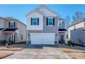 Two-story house with gray siding, white accents, and a two-car garage at 2123 Belterra Dr, Charlotte, NC 28216