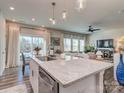 Kitchen island with granite countertop and stainless steel sink, open to living area at 2123 Belterra Dr, Charlotte, NC 28216