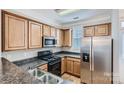 Efficient kitchen with stainless steel refrigerator, ample cabinet space, and sleek countertops at 155 Singleton Rd, Mooresville, NC 28117