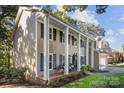 Two-story house with columns, brick walkway, and attached garage at 416 Sabot Ln, Matthews, NC 28105