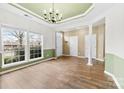 Open dining area with hardwood floors, two entryways and chandelier at 6428 Hasley Woods Dr, Huntersville, NC 28078