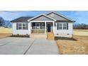 Newly built home with white siding, a covered porch, and a landscaped yard at 872 Old Mocksville Rd # 1, Statesville, NC 28625