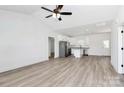 Bright, open-concept living room features modern lighting and beautiful flooring, leading into the kitchen area at 872 Old Mocksville Rd # 1, Statesville, NC 28625