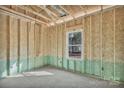 Unfinished room with exposed framing, wiring, and a single window at 872 Old Mocksville Rd # 1, Statesville, NC 28625