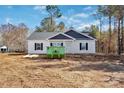 Charming one-story home with white siding, black shutters, and new construction in a wooded community at 882 Old Mocksville Rd # 2, Statesville, NC 28625