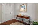 Home entryway featuring a wooden floor, console table, and a white front door at 1236 Avalon Pl, Matthews, NC 28104