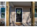 Black front door accented with a pretty spring wreath at 511 E Sycamore St, Lincolnton, NC 28092