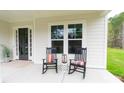 Inviting front porch with rocking chairs, a lantern, and a welcoming entry at 1875 Rock Hill Church Rd # 4, Matthews, NC 28104
