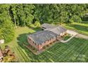 Aerial view of a brick home with landscaping and a walkway to the front door at 216 Delview Dr, Cherryville, NC 28021