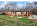 Attractive red brick home with manicured lawn and walkway enhancing the curb appeal and inviting entrance at 216 Delview Dr, Cherryville, NC 28021
