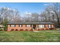 Quaint red brick home featuring a neatly kept lawn and classic design elements for a welcoming atmosphere at 216 Delview Dr, Cherryville, NC 28021