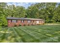 A ranch style brick home accented by shutters with a well maintained lawn at 216 Delview Dr, Cherryville, NC 28021