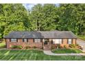 Classic brick home featuring a welcoming entrance, well-kept landscaping, and a shingled roof at 216 Delview Dr, Cherryville, NC 28021