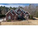 A stately brick home with well-maintained landscaping and elegant architectural details under a partly cloudy sky at 1038 Rolling Park Ln, Fort Mill, SC 29715