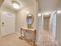 Bright entryway with hardwood floors, a console table, and mirror at 106 Fox Run Dr, Fort Mill, SC 29715