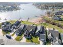 Stunning aerial view of waterfront homes with private docks and sandy beach access at 112 Sisters Cove Ct, Mooresville, NC 28117