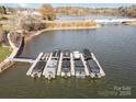 Aerial view of a boat dock featuring multiple covered boats on a sunny day at 112 Sisters Cove Ct, Mooresville, NC 28117