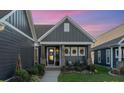 Gray two-story home with a welcoming front porch and landscaping at 112 Sisters Cove Ct, Mooresville, NC 28117