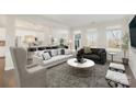 Open concept living room featuring a large sofa, marble table and stylish decor at 833 River Park Rd, Belmont, NC 28012