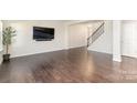 Living room with hardwood floors and a staircase at 833 River Park Rd, Belmont, NC 28012