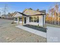 Newly built home with white siding, covered porch, and landscaping at 1316 Carmel Rd, Lancaster, SC 29720