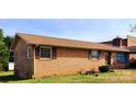 Charming single-story brick home showcasing mature landscaping and a classic roofline at 2040 Ne 25Th Street Dr, Hickory, NC 28601