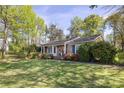 Inviting one-story brick home showcasing a well-kept lawn and colorful azalea bushes at 5431 Park Rd, Charlotte, NC 28209