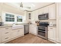 Bright kitchen featuring white cabinets, stainless steel appliances, and farmhouse sink at 5431 Park Rd, Charlotte, NC 28209