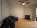 Living room with hardwood floors, fireplace, and sectional sofa at 104 Kensington St, Mooresville, NC 28117