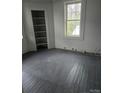 Bright bedroom with built-in shelving, light gray walls, and natural light from a window at 50 Ranlo Ave, Gastonia, NC 28054