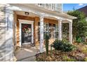 Inviting front porch with stone accents and a wreath on the door at 11131 Cypress View Dr, Charlotte, NC 28262