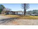 Single-wide mobile home with covered porch and spacious yard at 202 Mountain View Dr, Taylorsville, NC 28681