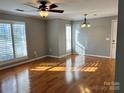 Sunlit living area showcasing hardwood floors and stylish shuttered windows at 2518 Cranbrook Ln, Charlotte, NC 28207