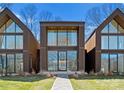 Contemporary homes showcase striking window designs and modern architecture, creating an inviting facade at 4026 Chevington Rd # 102, Charlotte, NC 28226