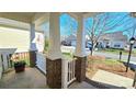 Brick porch with white railings, offering a view of the neighborhood at 1001 Jessica Ln, Matthews, NC 28104