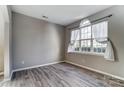 Living room with hardwood floors, large window, and neutral wall colors at 3116 S Legacy Park Blvd, Fort Mill, SC 29707