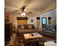 Cozy living room featuring a wood-burning stove, comfortable seating, and rustic wood and bear themed accents at 369 Pinecrest Cir, Troy, NC 27371
