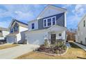 Two-story house with gray and white siding, stone accents, and a two-car garage at 5762 Soft Shell Dr, Lancaster, SC 29720