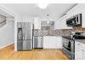 Bright kitchen with stainless steel appliances and granite countertops at 9149 Washam Potts Rd, Cornelius, NC 28031